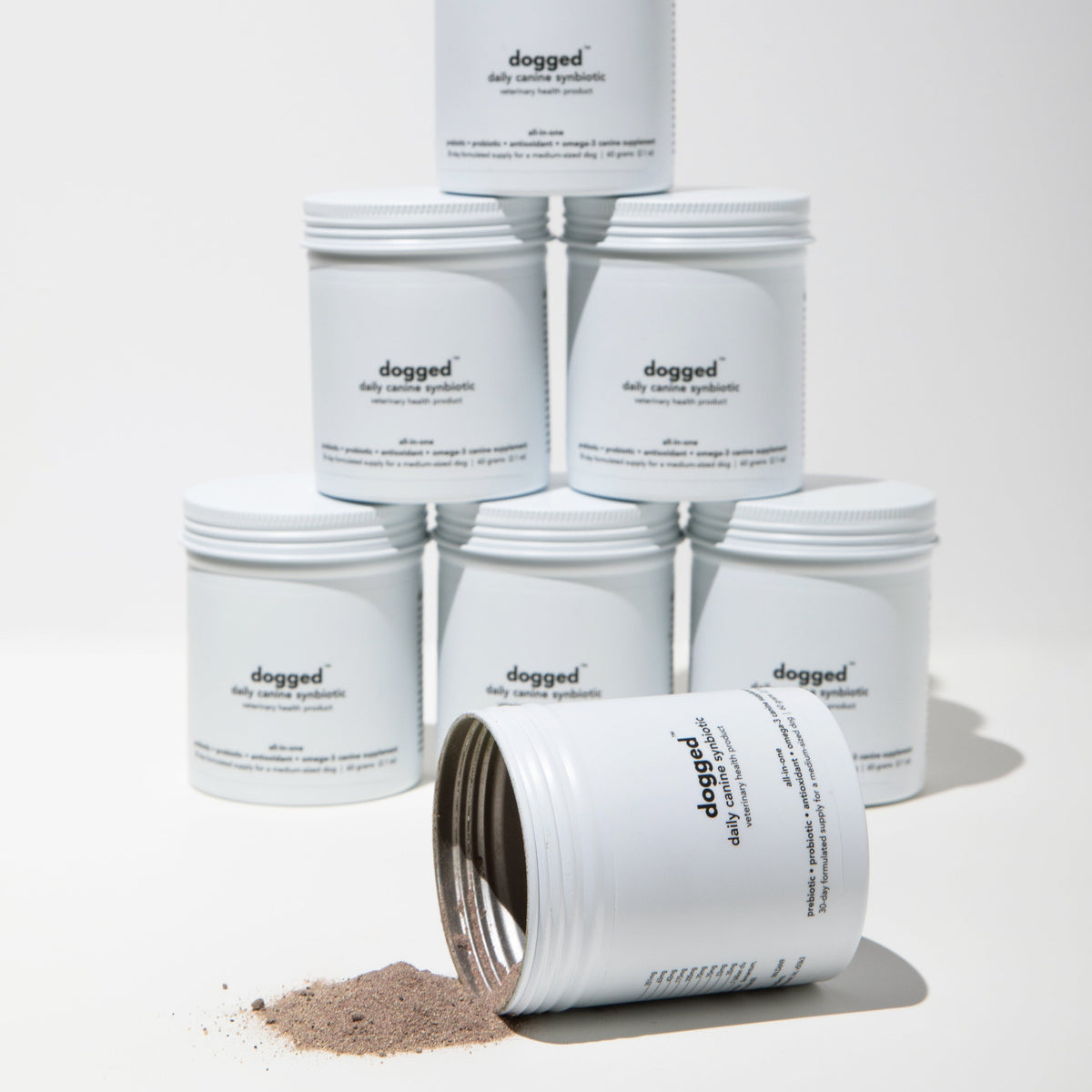 Stack of dogged daily canine synbiotic products on a white background