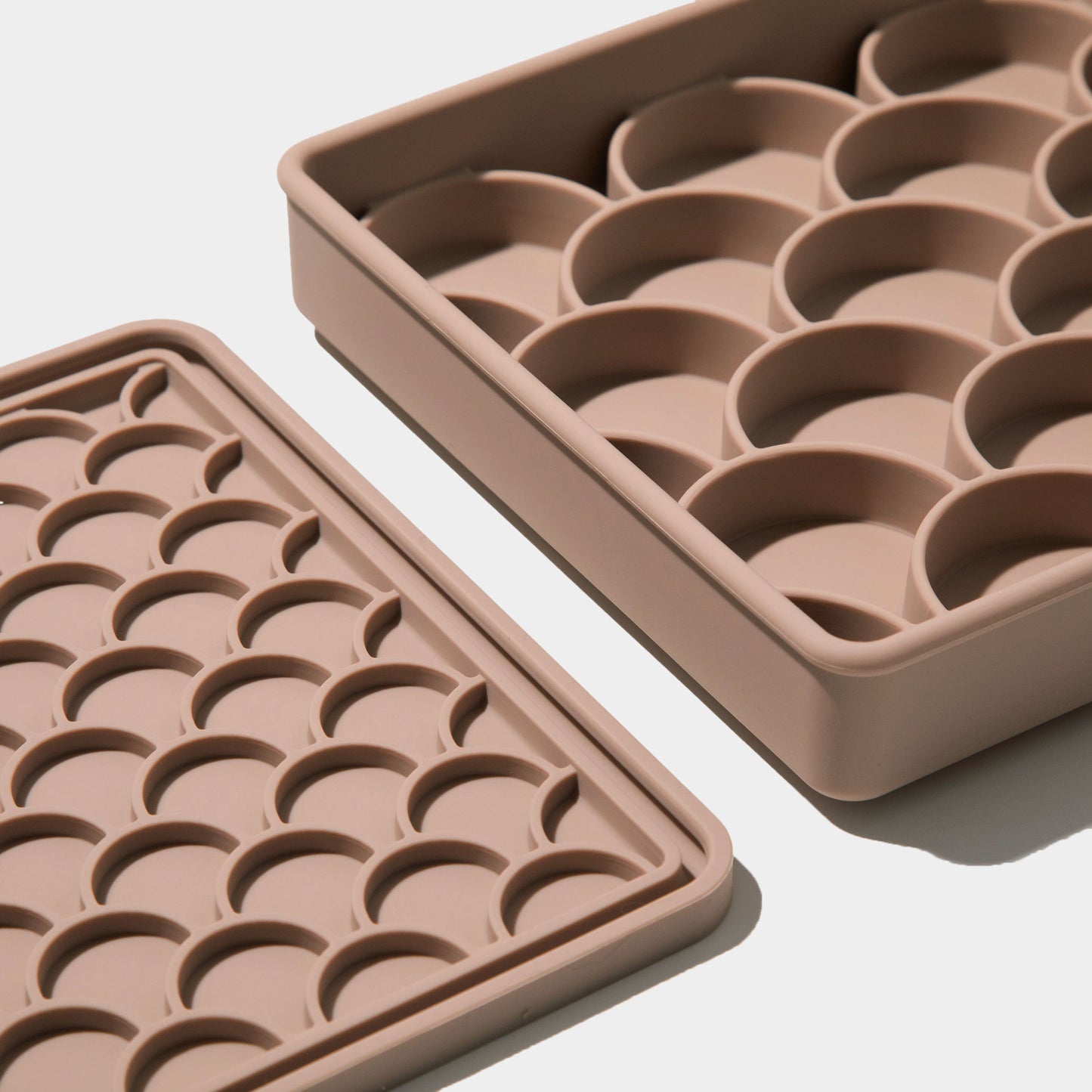 detailed side angle of the slow feeder and its lid in fig, emphasizing the texture and depth of the fish scale design for engaging mealtime enrichment.